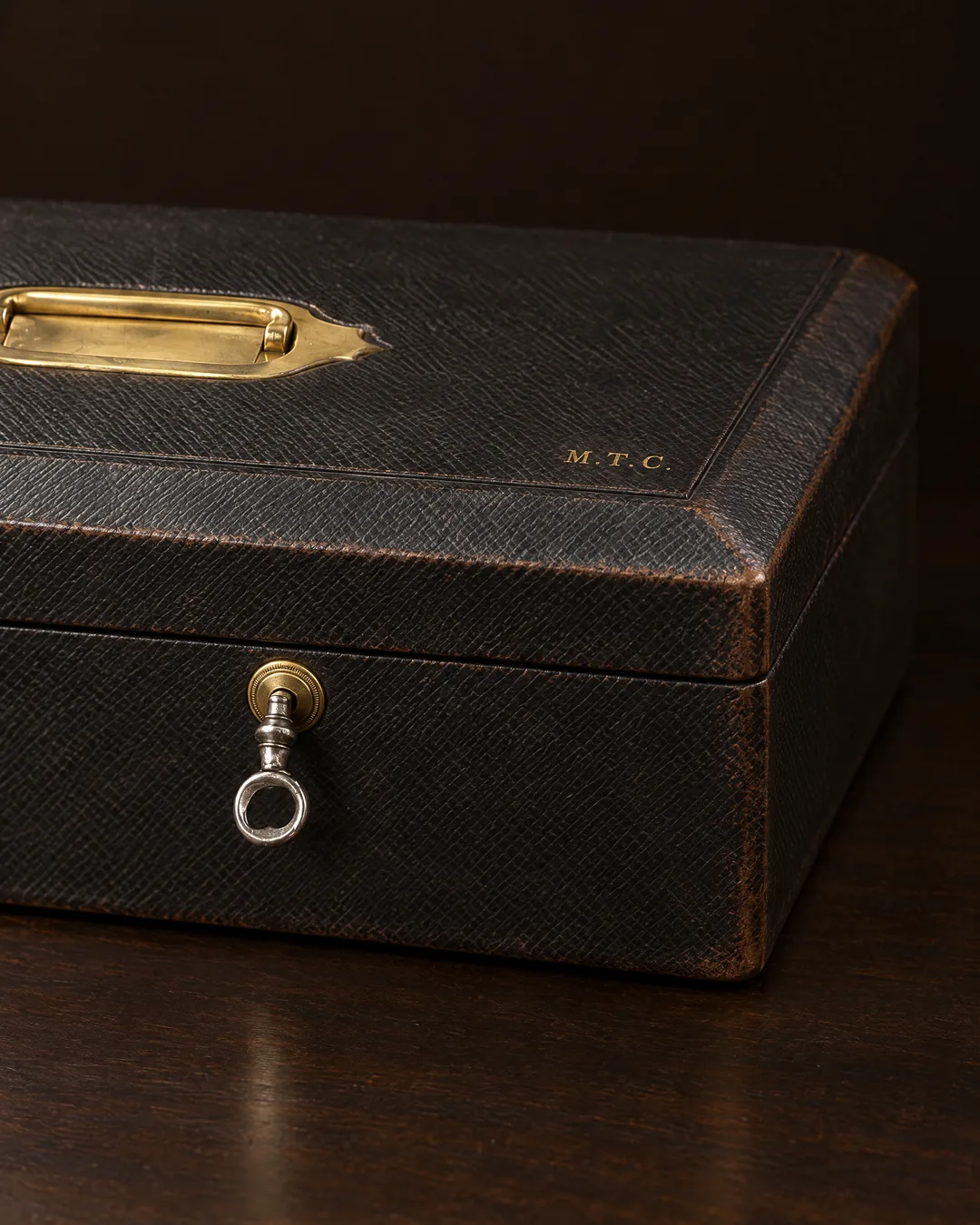 A Victorian black Morocco despatch box with a brass handle, the gilt initials M.T.C. and a Bramah lock with its key