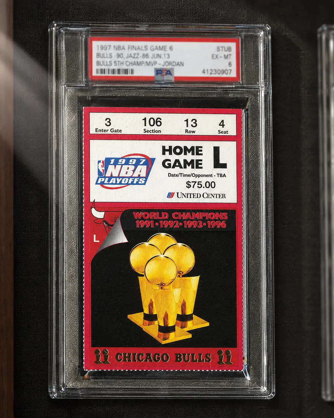 A graded ticket stub from the 1997 NBA Finals, red-bordered with four gold trophies, mounted in a walnut shadow box