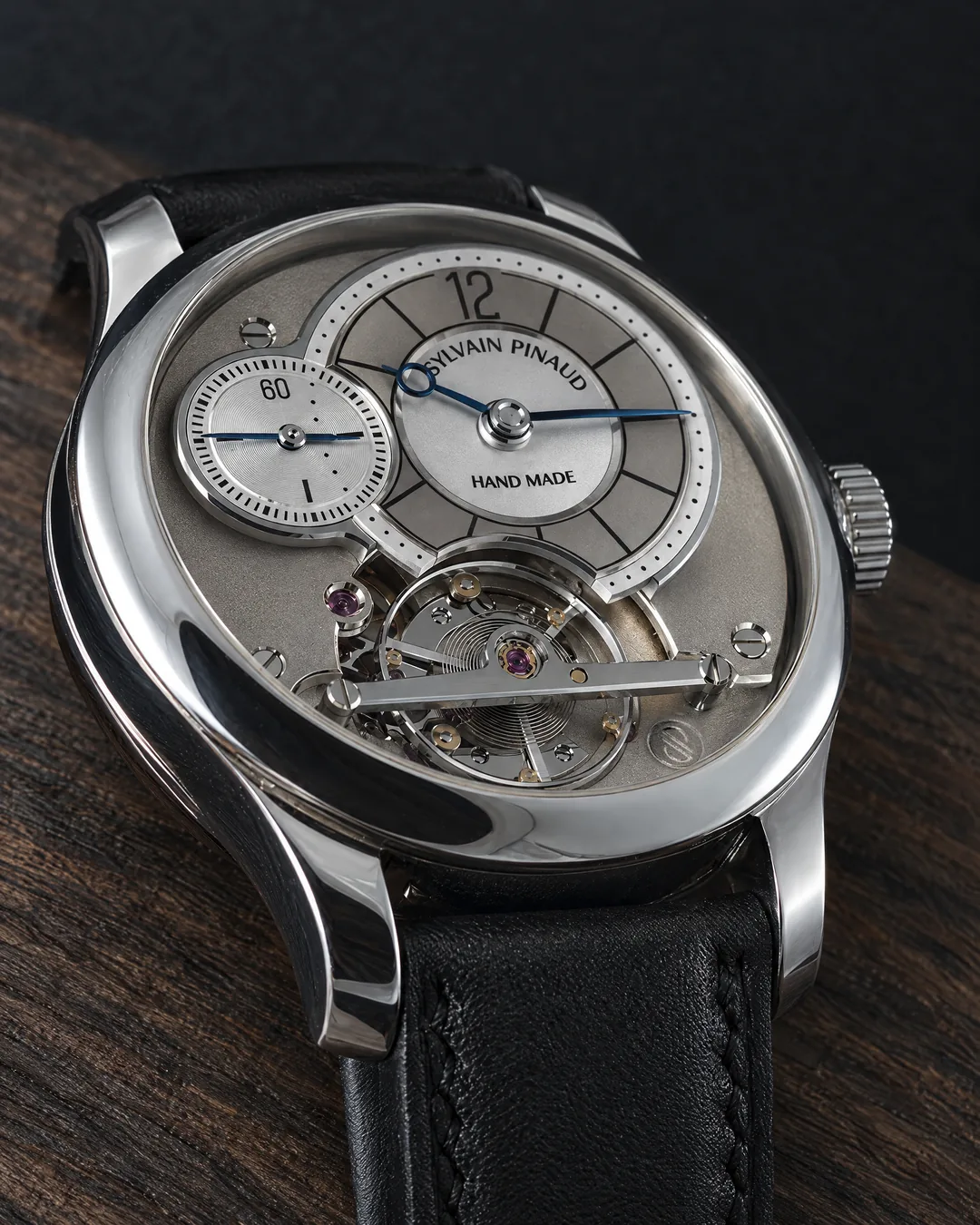 A hand-made steel wristwatch signed Sylvain Pinaud, with a silvered dial and open movement