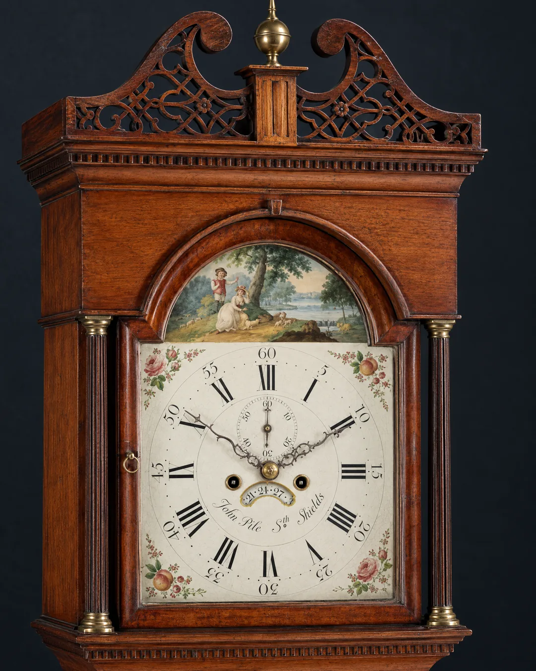 A Georgian longcase clock by John Pile of South Shields, its painted arch dial and oak hood